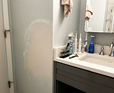 San Marcos Drywall Repair bathroom wall damage from door swinging into it